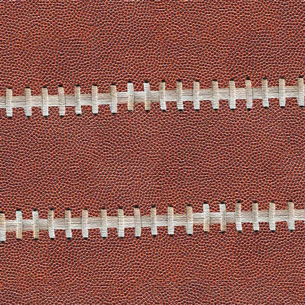 Close-up of a brown football with white stitching