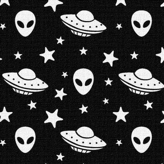 A textured Pattern of white aliens, UFOs, and stars on a black background